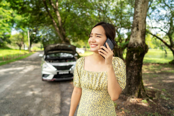 istock Asian woman calling emergency service with broken car at background 1410227301