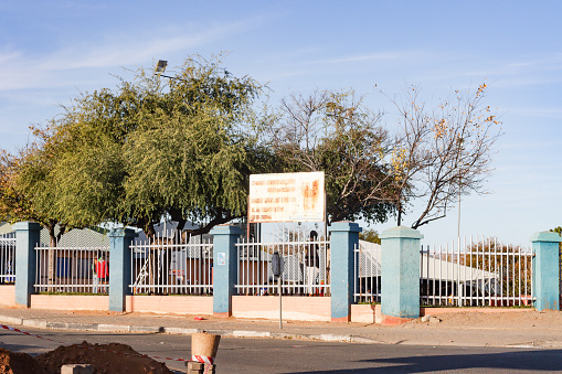 Katutura Township in Windhoek at Khomas Region, Namibia, with a commercial sign visible and people in the background.