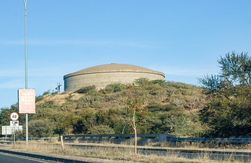 Water Tower near Windhoek in Khomas Region, Namibia, with an advertising sign and phone number visible.
