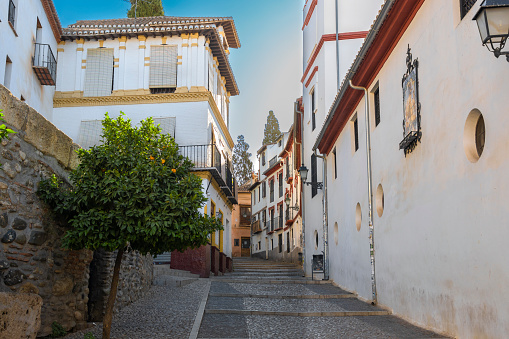 San Gregorio Street with traditional white houses in the old quarter of Granada, Spain