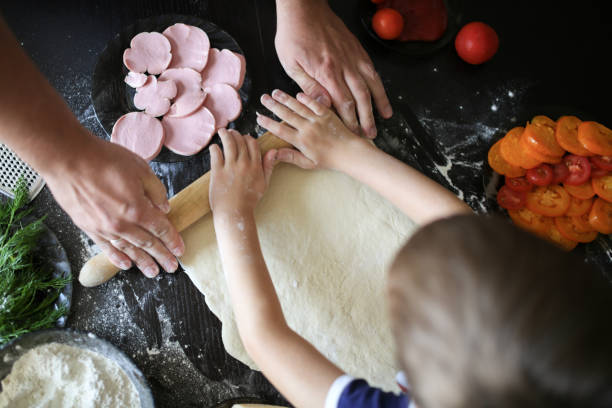 istock boy and dad  rolled dough in cozy interior 1410230872
