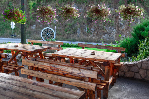 Rustic terrace Rustic terrace with wooden tables . Road Cafe at Countryside wagon wheel bench stock pictures, royalty-free photos & images