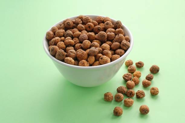 istock Chufa, tigernut, earth almond on ceramic bowl on green background 1410233532