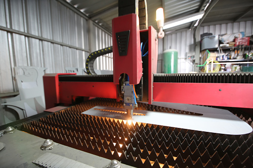 Plasma cutting, High precision CNC laser cutting metal sheet and metal pipe in factory.