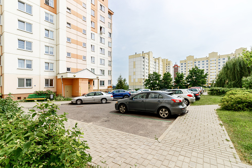 Parking for cars in the courtyard of an apartment building with cars standing on it