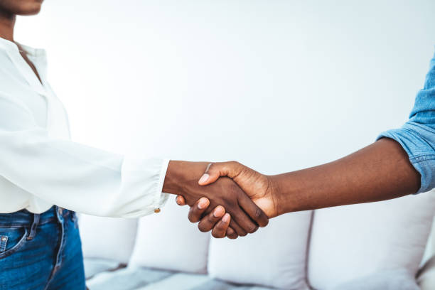 istock Businessman standing greeting partner with handshake 1410236427