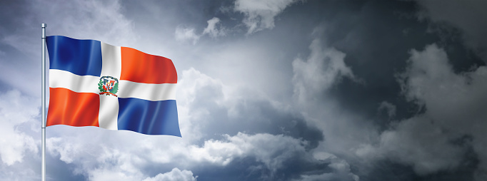 Dominican Republic flag on a cloudy sky, three dimensional render