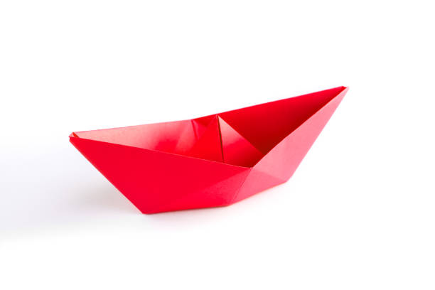 istock Red paper boat origami isolated on a white background 1410240788