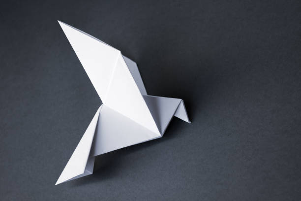 istock White paper dove origami isolated on a grey background 1410240866