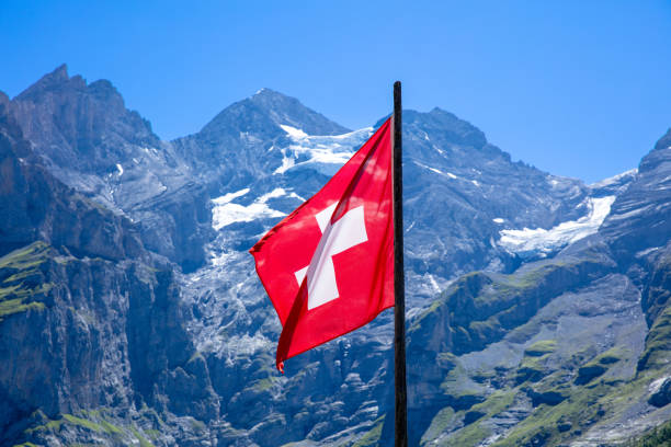 istock Swiss flag and alps mountain 1410240911