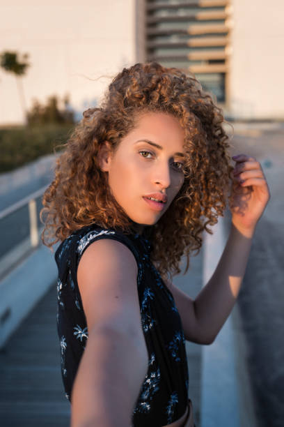istock Charming woman taking selfie on street 1410243794