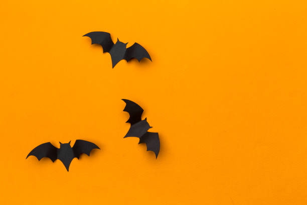 istock halloween and decoration concept - paper bats flying 1410245099