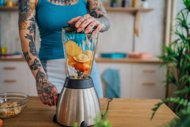 istock Woman making a healthy smoothie with fresh fruit 1410246635
