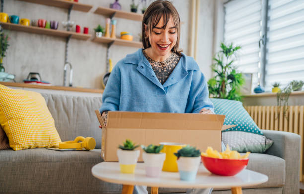 istock Woman unpacking cardboard delivery package 1410247850