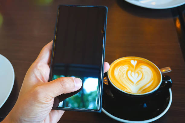 istock Nomad digital man with a coffee  cup break  on the table as using or looking at his smartphone in  cafe restaurant 1410249724