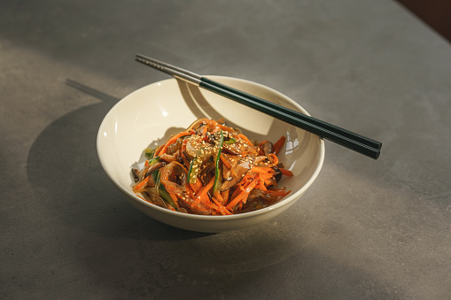 Japchae is a traditional Korean food which is mixed dish of boiled bean threads, stir-fried vegetables, and shredded meat