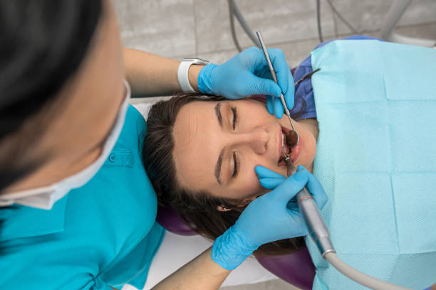 top view of female patient teeth whose teeth looks at dentist woman. stock photo