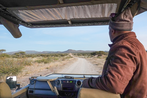 Guide looking at the view of Omboroko Mountains near Otjiwarongo at Otjozondjupa Region, Namibia