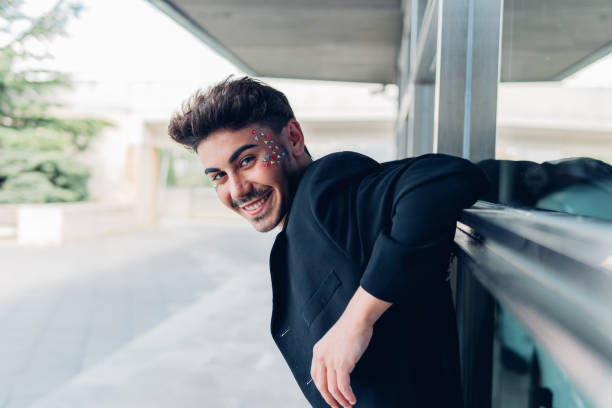 istock Cheerful man with rhinestones on face 1410252707
