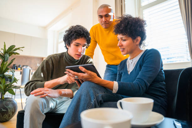 Hispanic Family Using Digital Tablet Together in Living Room