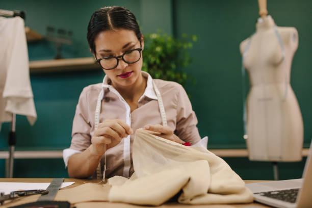 istock Female fashion designer doing handwork on dress 1410254155