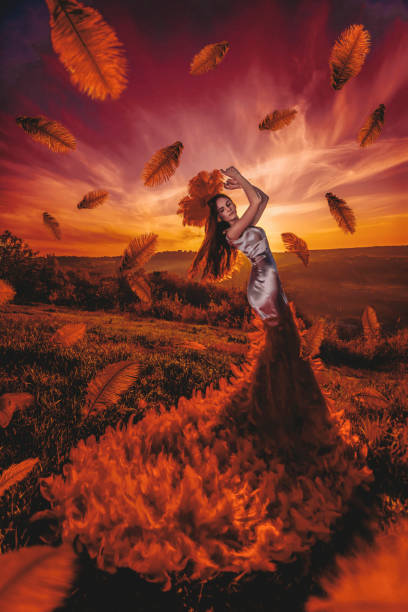Beautiul woman in sunset with feathers