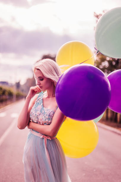 Beautiful woman with many balloons