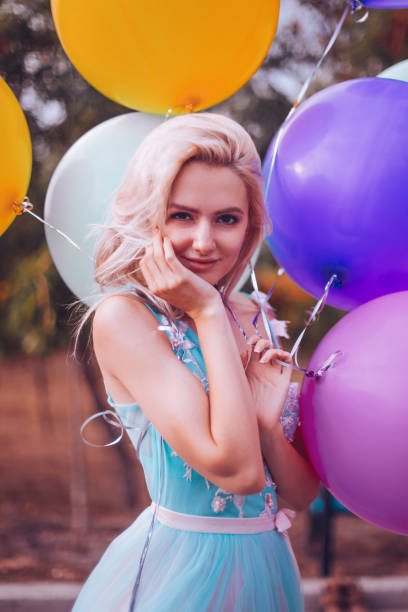 istock Beautiful woman with many balloons 1410256032