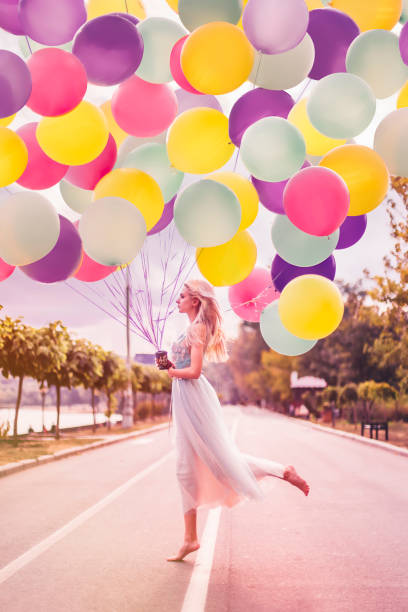 istock Beautiful woman with many balloons 1410256033
