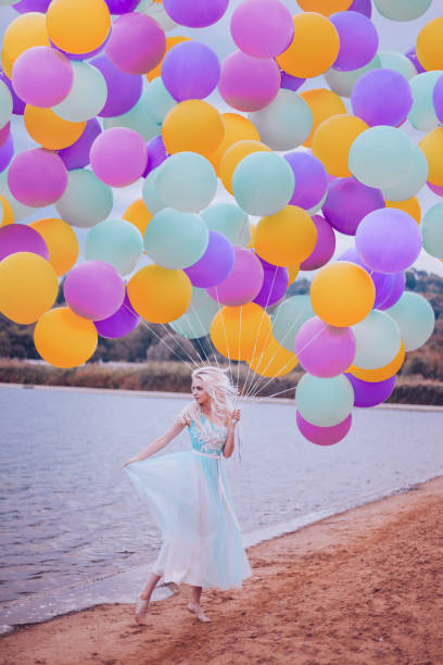 istock Beautiful woman with many balloons 1410256053