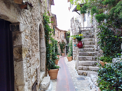 view of the narrow streets and stone houses of eze village in the french riviera