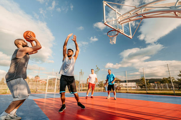 istock Friends Playing Basketball Outdoors 1410257501