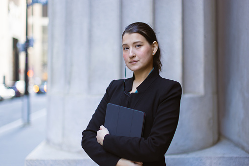 Hispanic latin female lawyer in front of the court house. Downtown Manhattan, New York, USA