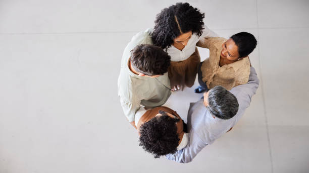 istock Diverse businesspeople standing arm in arm in a circle 1410259142