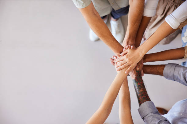 istock Diverse businesspeople standing with their hands stacked together 1410259289