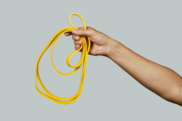 istock man with a yellow resistance band 1410261027