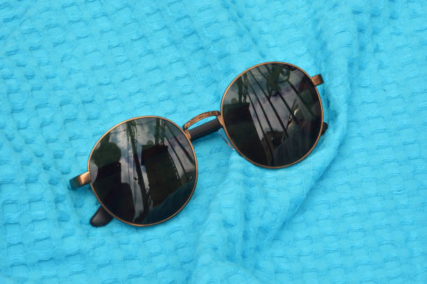 istock sunglasses on a turquoise towel. summer vacation. background for the design. 1410261336
