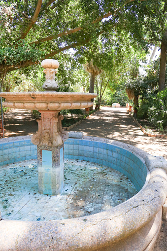 Cartagena, Murcia, Spain- July 18, 2022: Stone fountain in the garden of Beltri House in Cartagena