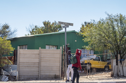 Tugela Street at Wanaheda Township near Windhoek in Khomas Region, Namibia, with people walking past.