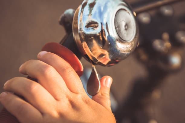 child hand presses the bicycle bell stock photo