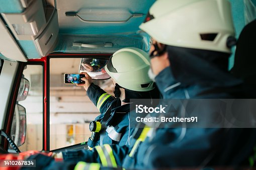 istock Two firemen taking a selfie 1410267834