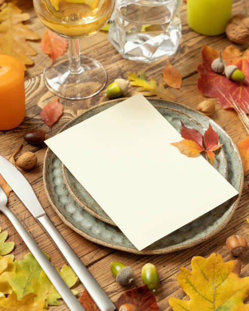 istock Autumn rustic table setting with blank card between leaves and berries close up, mockup 1410268831