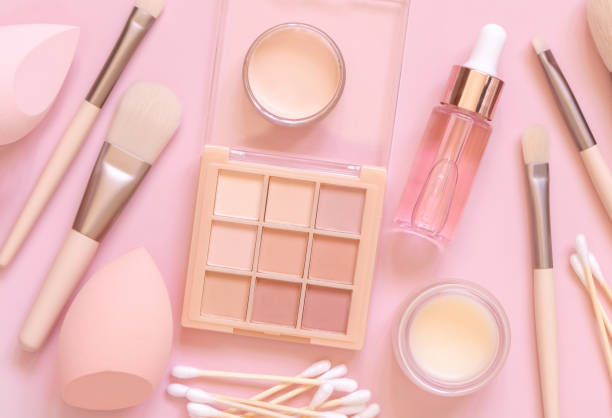 istock Natural beige eye shadow and decorative cosmetics on light pink, top view 1410268833