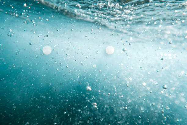 istock Underwater View of Bubbles In Deep Blue Ocean. Close Up Water. Background 1410270066