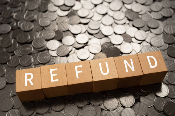 Wooden blocks with "REFUND" text of concept and coins. Wooden blocks with "REFUND" text of concept and coins. refundable stock pictures, royalty-free photos & images