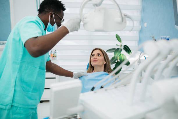 istock Dentist preparing his female patient for the procedure 1410272682