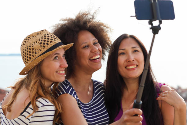 istock Mixed race female friends making a selfie 1410274151