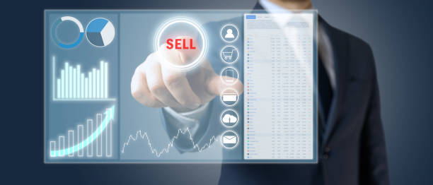 istock Businessman or manager pressing button sell on the virtual screen with graphs, business concept 1410274403