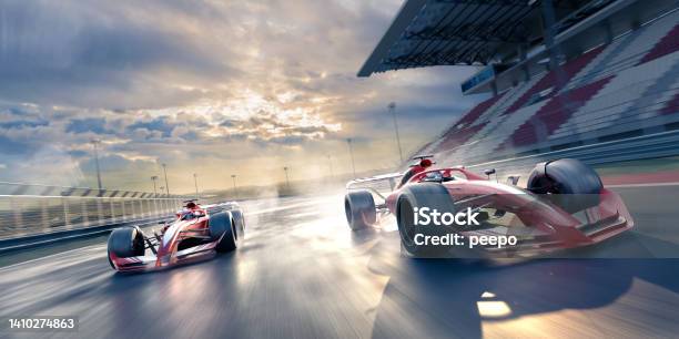 Two Race Cars Moving At High Speed In Slightly Wet Conditions Stock Photo - Download Image Now