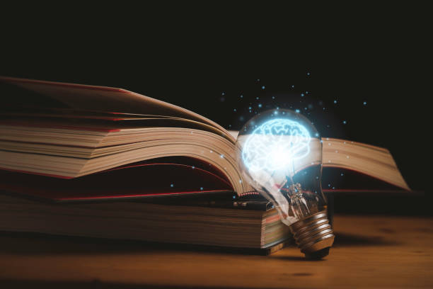 istock Virtual drawing of glowing blue brain with open book for knowledge study and education can make creative thinking idea concept. 1410276947